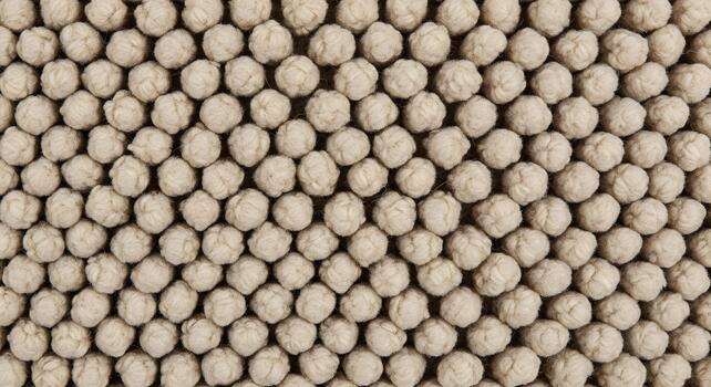 de cerca de un texturizado beige alfombra con pequeño, redondeado fibras, creando un uniforme y atractivo superficie foto