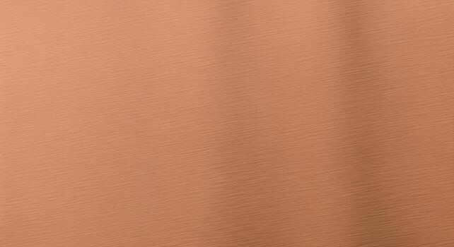 Close-up textured metallic copper surface with subtle diagonal lines and soft shadows, creating a warm and industrial background photo