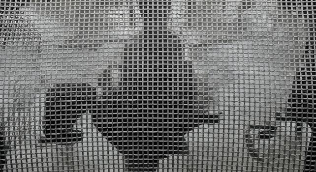 Abstract background with textured grid pattern and blurred dark shapes providing a modern and sophisticated aesthetic photo