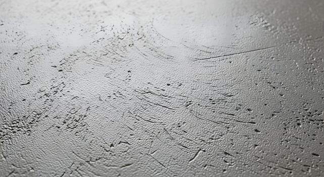 Textured gray surface with rough, detailed patterns creating an abstract, artistic background photo