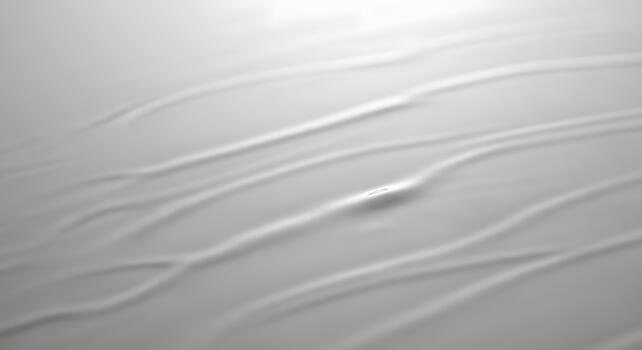 Soft white abstract texture of a creamy liquid surface with smooth, flowing lines creating a tranquil, minimalist background pattern photo