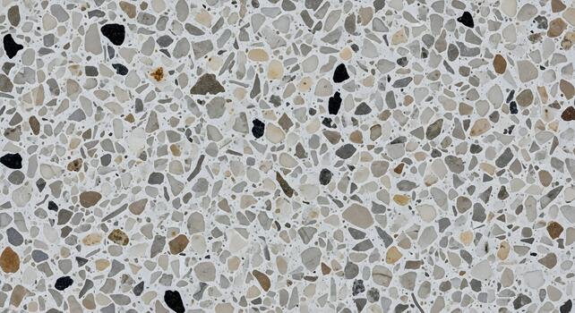 Abstract background of polished terrazzo stone texture, with grey, black, and beige speckles in a light-colored composite surface photo
