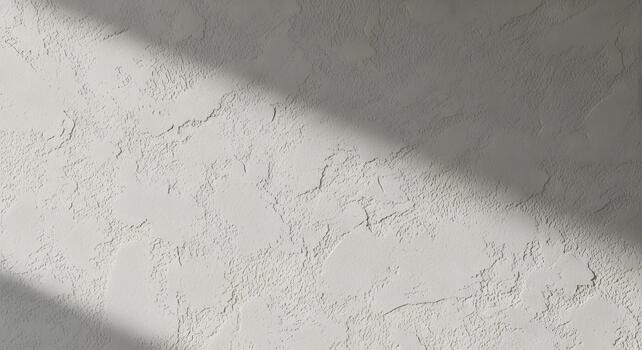 Textured white wall with natural light and shadow patterns, perfect for backgrounds photo