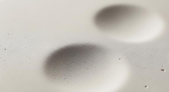 Abstract textured background with shallow indentations and subtle cracks, creating a tactile surface with depth and visual interest photo