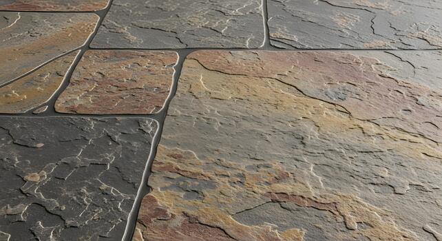 Detailed close-up of a weathered, textured stone tile floor with variations in color and pattern photo