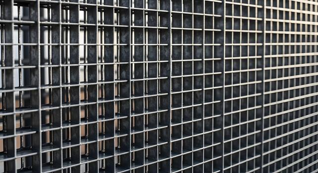 Close-up view of a metallic grid pattern, showcasing its intricate geometric structure and industrial texture photo