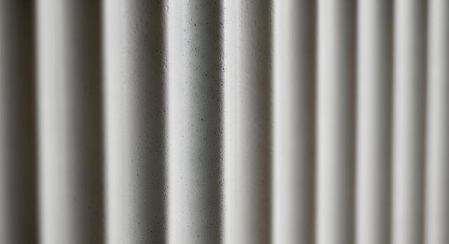 Abstract perspective of a modern white ribbed wall, highlighting the subtle texture and interplay of light and shadow, creating a dynamic visual pattern that suggests architectural minimalism photo