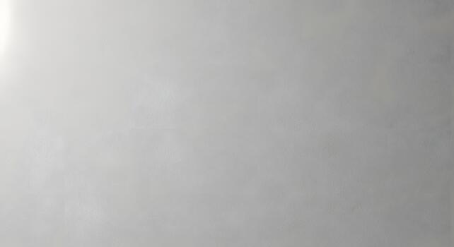 Subtle and elegant light grey wall texture with a smooth, soft concrete appearance, offering a versatile minimalist background for modern design, architectural photography, or clean graphic layouts photo