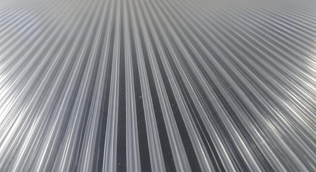 Abstract view of a clear corrugated plastic sheet, pattern of parallel lines in transparency photo
