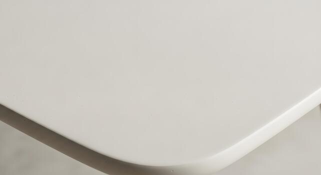 Close-up texture of a smooth, light-colored surface with subtle imperfections and rounded edges, suggesting a modern design or material photo