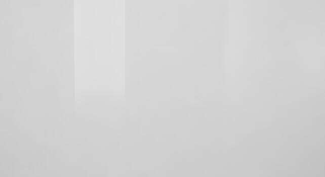 Minimalist white glossy surface background with subtle vertical reflections creating a smooth, clean, and modern abstract wall texture photo