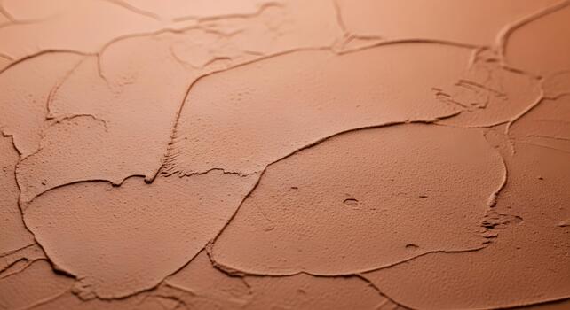 Close-up textured surface of a smooth, earthy toned material, showing subtle undulations and organic patterns photo