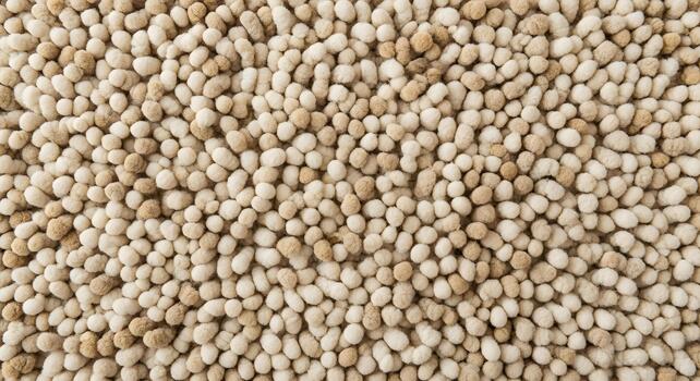 Close-up of a Textured Carpet Showing a Pattern of Small, Round Bumps in Beige Tones photo