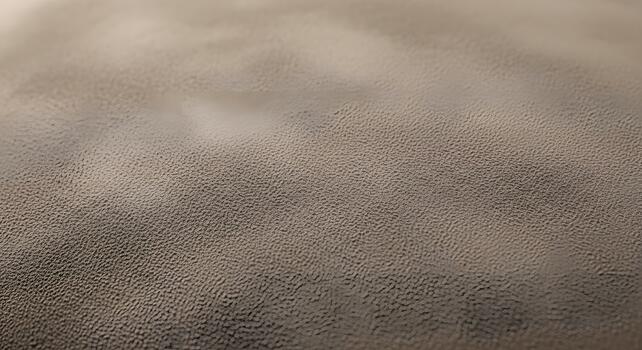 Close-up of a dark, granular texture with subtle light reflections, revealing intricate patterns. This abstract surface provides a sophisticated and versatile background photo