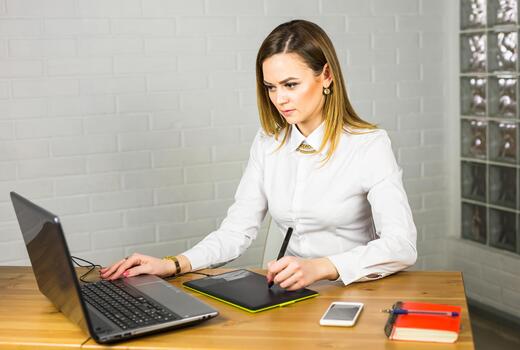 Graphic designer using digital tablet and computer in office. photo