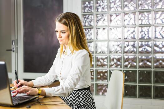 Female designer using graphics tablet while working with computer. Copy space. photo