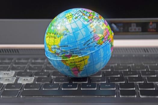 Laptop keyboard with world globe on top. photo