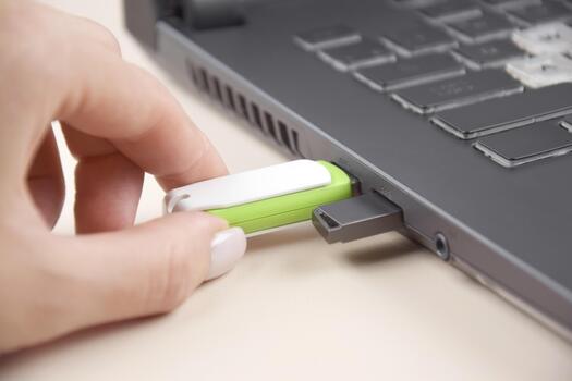 The USB memory stick or flash drive on the keyboard of an open laptop. photo