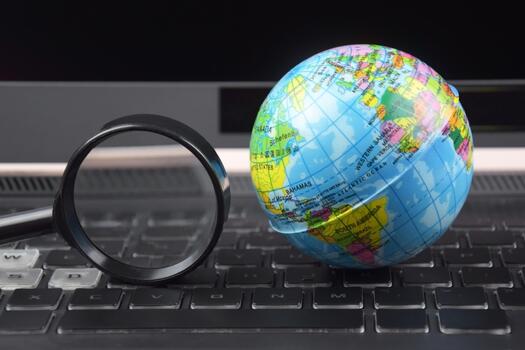 The Laptop keyboard with world globe on top photo