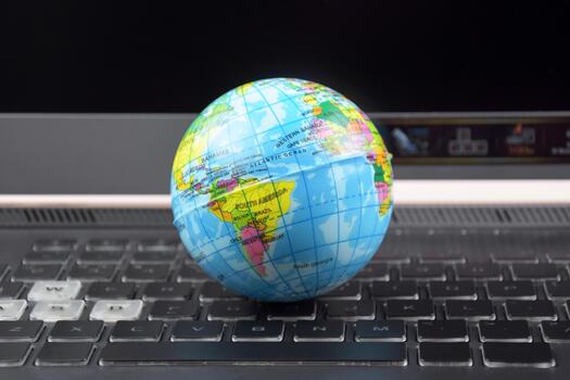 A Laptop keyboard with world globe on top photo