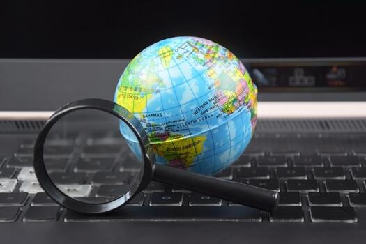 A Laptop keyboard with world globe on top. photo