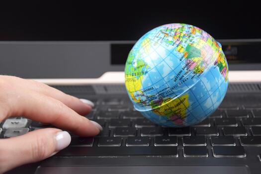 The Laptop keyboard with world globe on top. photo