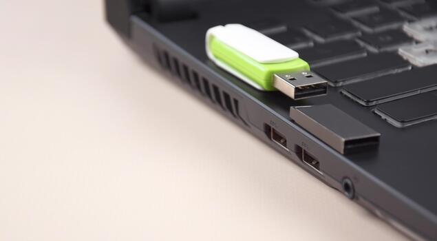 Two USB memory stick or flash drive on the keyboard of an open laptop. photo