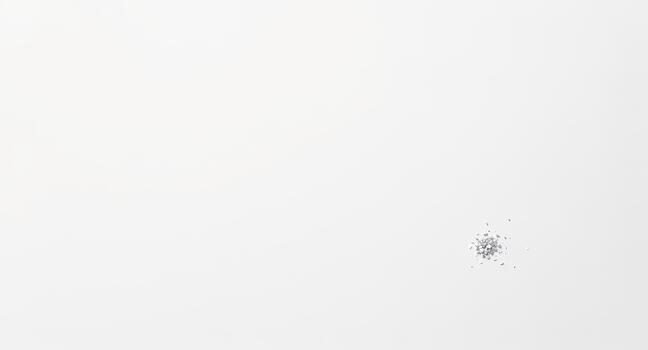 Tiny metallic fragments scattered across a clean white background, suggesting precision, technology, or delicate details. photo