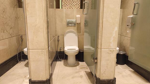 Luxurious Public Restroom with Marble Tiling and Multiple Stalls photo