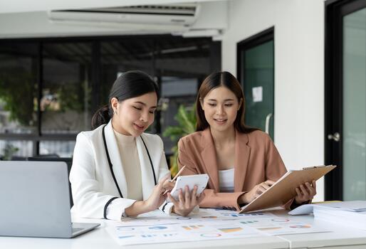 Business team finance or bookkeeper working with a calculator to calculate business data summary report, accountancy document and laptop computer at the office, business meeting concept photo