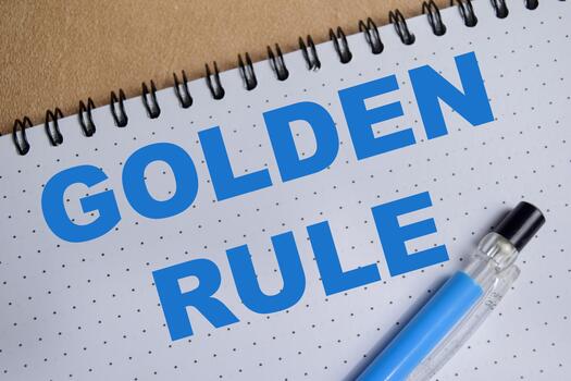 Concept of golden rule write on book isolated on Wooden Table. photo