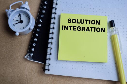 Concept of solution integration write on sticky notes isolated on Wooden Table. photo