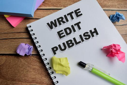 Concept of write edit publish write on book isolated on Wooden Table. photo