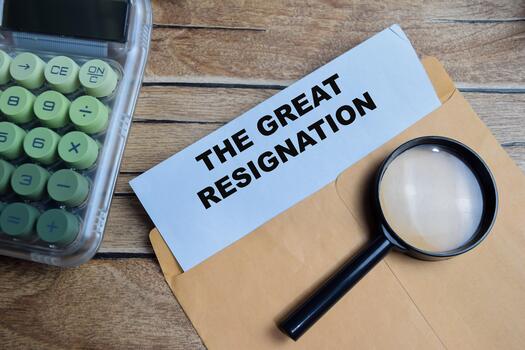 The great resignation text on document above brown envelope. photo