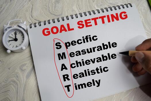 Concept of goal setting and smart write on book isolated on Wooden Table. photo