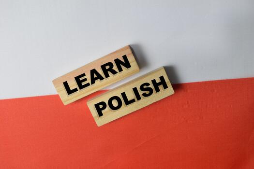 Learn Polish text stacked wooden cubes and Poland flag background. photo