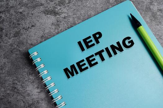 Concept of IEP meeting write on book isolated on Wooden Table. photo