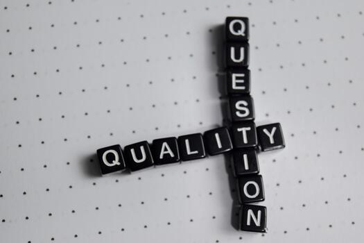 Concept of quality and question written on wooden blocks. photo