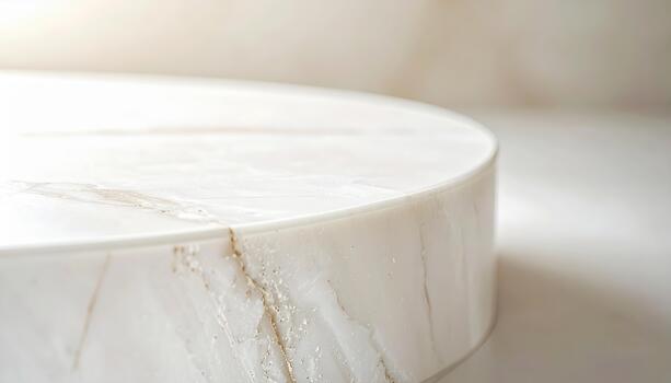 A close up view reveals the smooth rounded edge of a luxurious white marble surface, showcasing its natural veins and elegant design element. photo