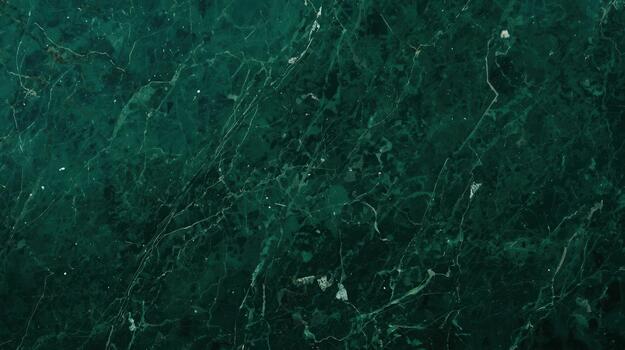 An intricately veined dark emerald green marble slab presents a polished natural stone surface ideal for luxurious designs and architecture use. photo