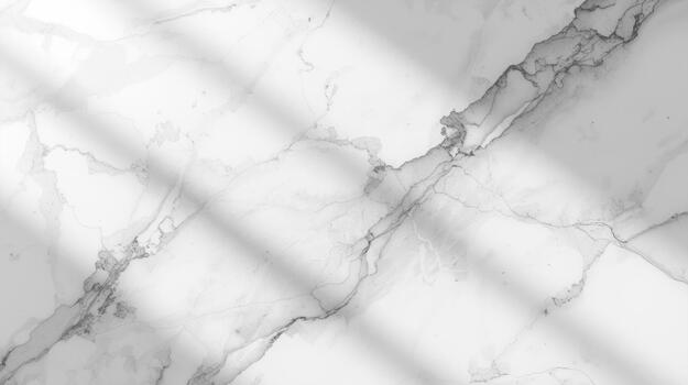 The elegant white marble surface with subtle gray veining is bathed in soft light creating a beautiful and calming abstract background effect. photo