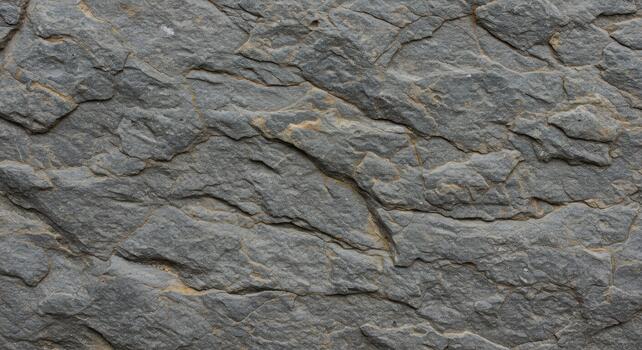 Detailed natural stone texture reveals intricate patterns and rugged surface, providing a captivating and raw aesthetic appeal for creative projects. photo