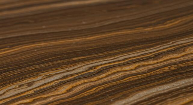 Close-up perspective reveals the beautiful layered patterns and textures of a natural brown and tan rock surface with smooth flowing lines. photo