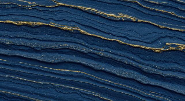 An abstract navy blue texture displays simulated rock strata interspersed with shimme gold veins to create a luxurious backdrop design. photo