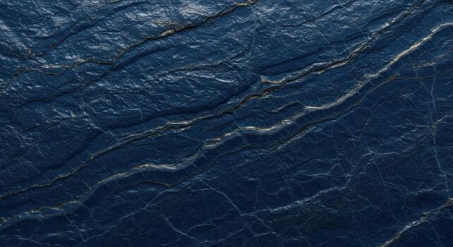 Abstract close up of dark blue textured rock surface with mineral veins creating a unique organic pattern on the natural stone background. photo