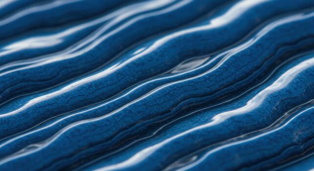 Macro photograph shows intricate blue wavy pattern with white highlights creating textured liquid ocean appearance surface closeup detail. photo
