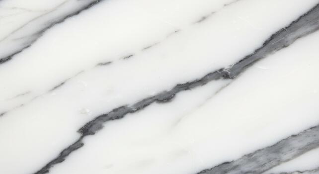 Elegant white marble texture with grey veins running diagonally across the surface creating a sophisticated and luxurious natural stone pattern. photo