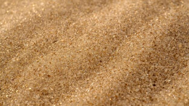 The golden surface of fine sand shimmers in the sunlight creating a dazzling texture on a sunny beach coastline, offe a warm vacation mood. photo