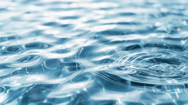 The serene surface of the water ripples and reflects the sunlight creating a calming and mesmerizing effect with subtle circular patterns. photo