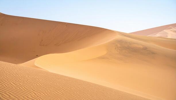 Vast desert landscape with rolling sand dunes creating a serene and majestic view under a clear blue sky in a remote location du daylight. photo